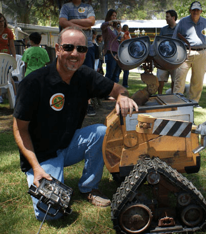 Photo of a man and Wall-E robot